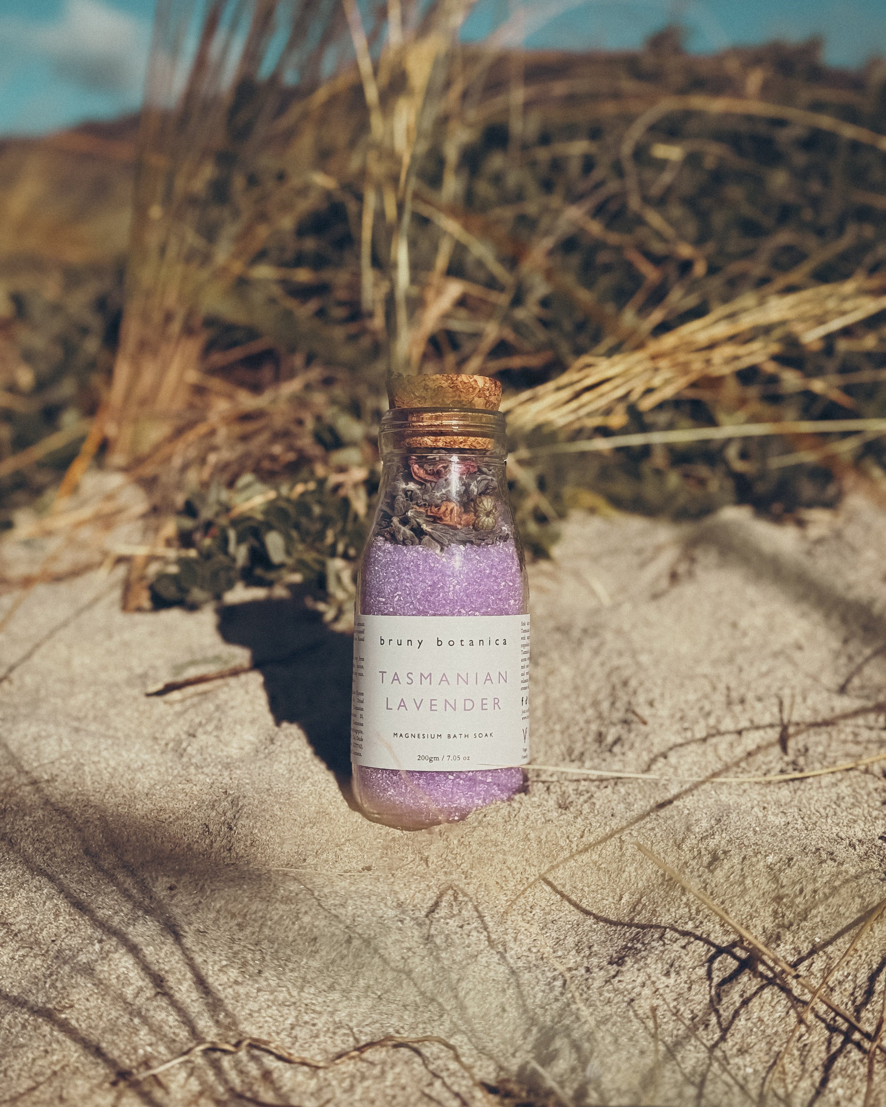 Tasmanian Lavender Magnesium Bath Soak against a coastal background